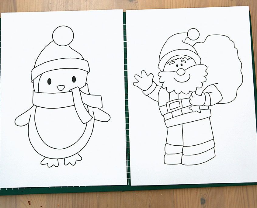Kalın kağıda basılmış penguen ve çuvallı Noel Baba boyama çizimleri, hamurla doldurulmayı bekliyor