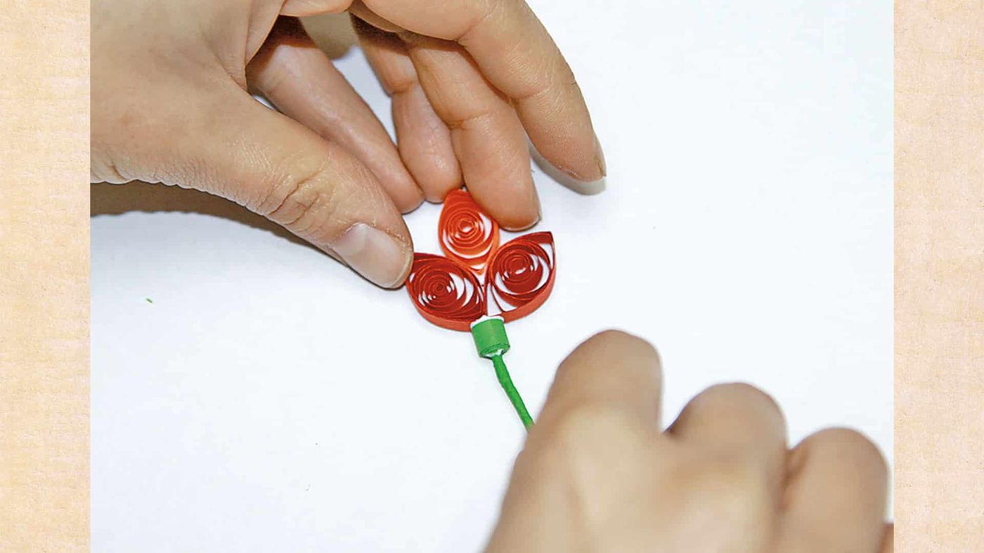 Kırmızı quilling taç yaprakların yeşil sapın ucuna tutturulması