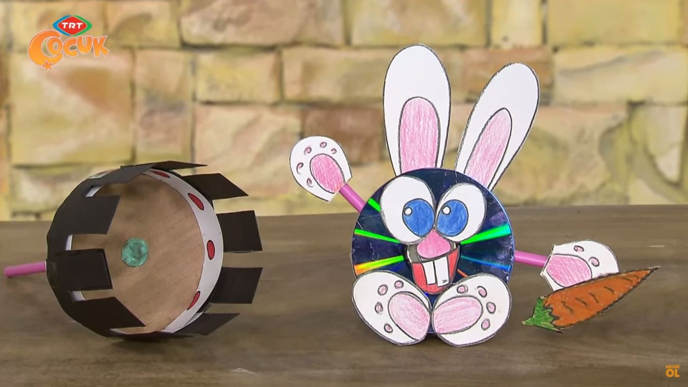 Program karesi: masada yan yana yarıklı karton zoetrope silindiri ve CD'den tavşan kukla