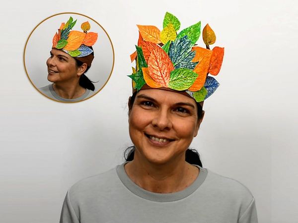 Yaprak tacı: renkli boyanmış kağıt yapraklardan taç takmış gülümseyen bir yetişkin