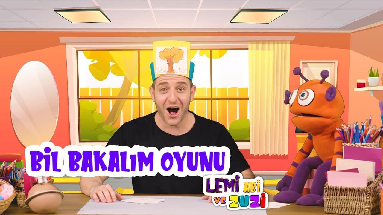 Bil Bakalım Oyunu video kapağı: başında kağıt bant olan sunucu ve antenli turuncu kukla